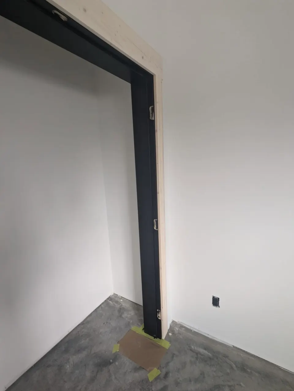 Black painted door jamb against crisp white walls