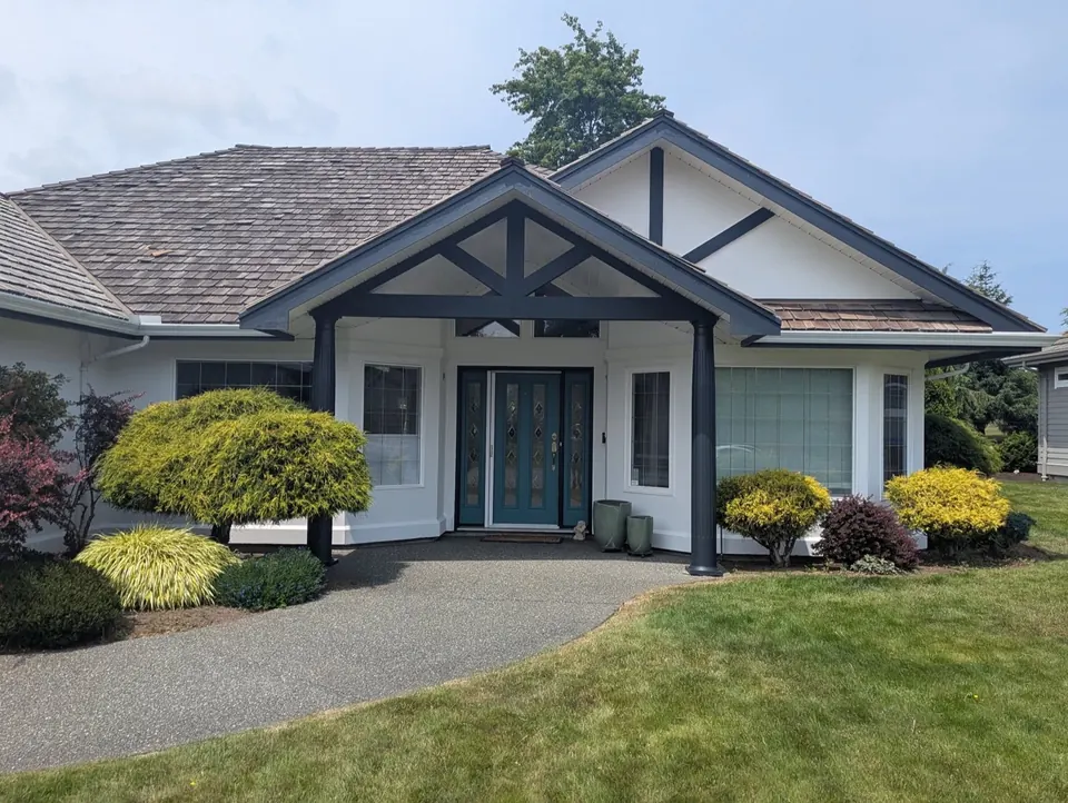 White house with dark grey trim and a teal front door, exterior repaint by Rory Somers Painting in the Comox Valley