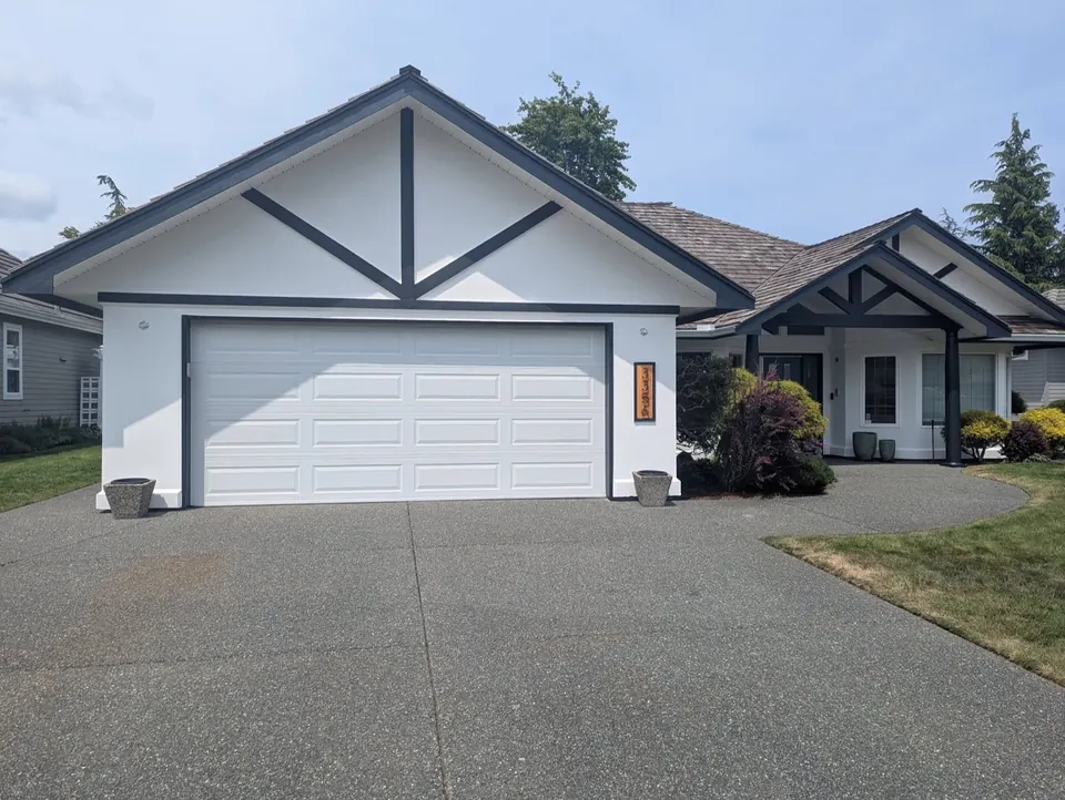 Garage side of a white house with dark trim