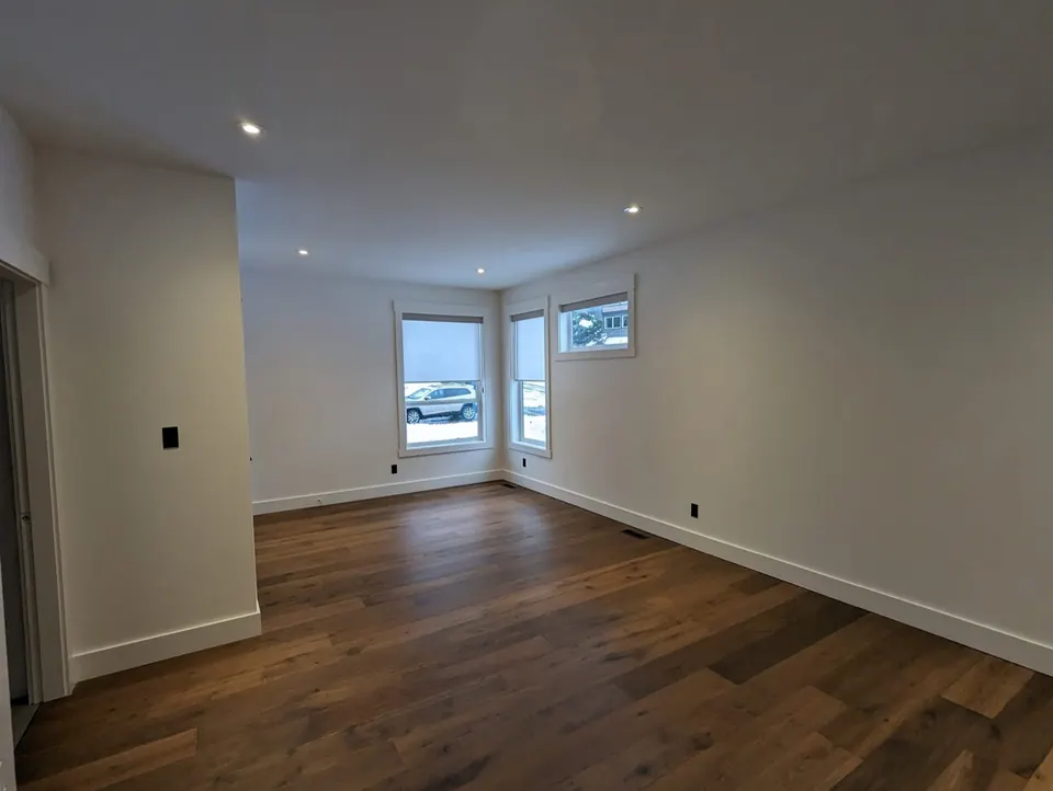 Bright condo bedroom with a dark feature wall
