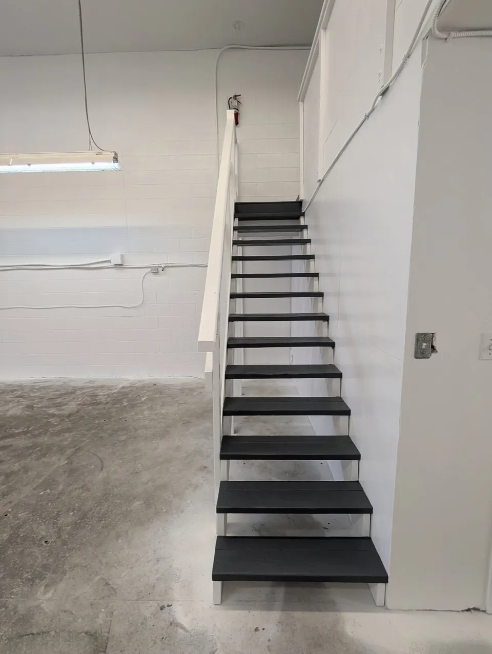 White walls and black painted stairs in a shop