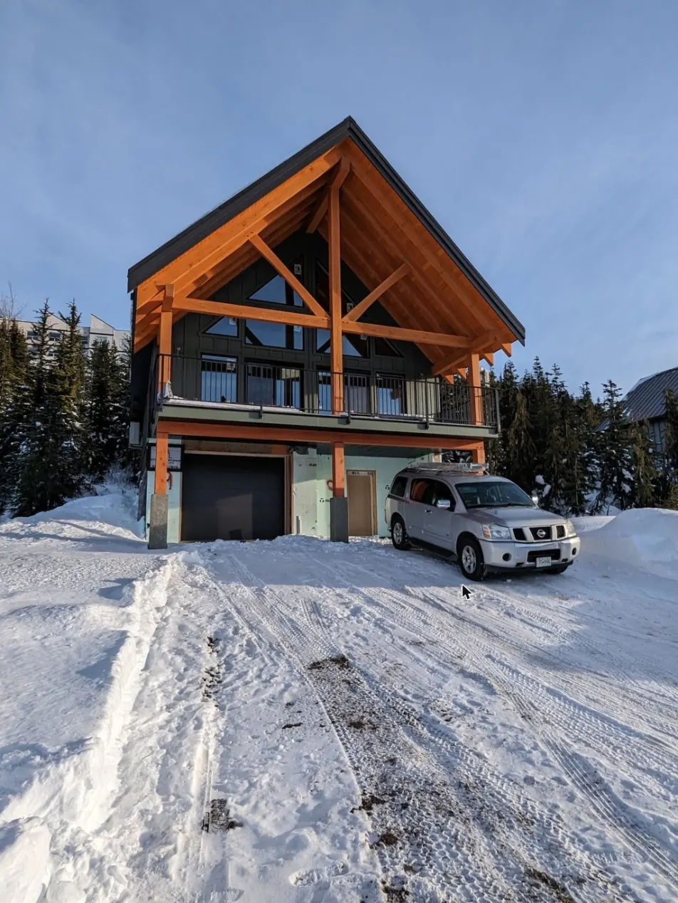 Timber-frame home under construction in winter
